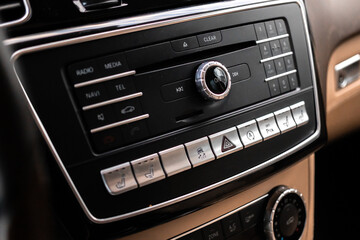 Modern car dashboard with multimedia screen. Interior detail, luxury vehicle close-up view...