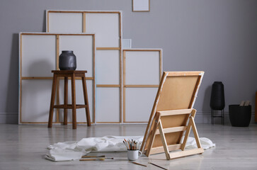 Stylish artist's studio interior with canvas and brushes