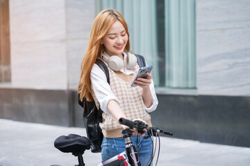 Young Asian woman using bicycle as a means of transportation - Powered by Adobe