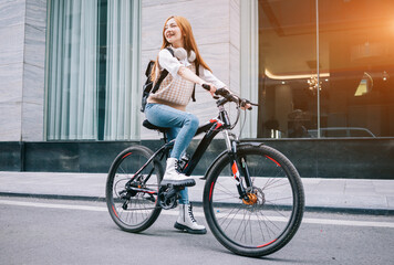 Young Asian woman using bicycle as a means of transportation