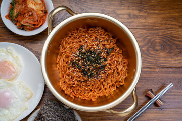 Korean traditional Ramyeon noodle in a traditional korean noodle pot, Spicy Korean Ramyeon instant...