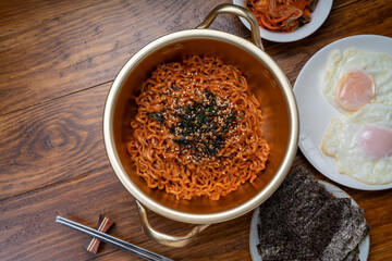 Korean traditional Ramyeon noodle in a traditional korean noodle pot, Spicy Korean Ramyeon instant noodle a traditional dish.