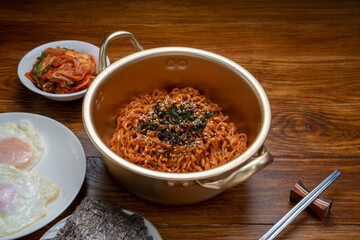 Korean traditional Ramyeon noodle in a traditional korean noodle pot, Spicy Korean Ramyeon instant...