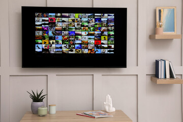 Modern TV on white wall in room
