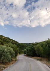Fototapeta na wymiar Countryside road in Greece with olive trees and hills.