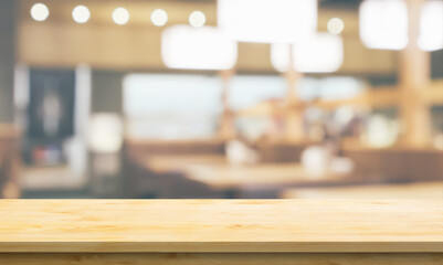 Empty wood table top with cafe restaurant interior blurred background
