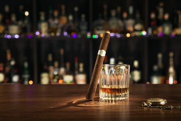 close up view of cigar and glass of whiskey on color back.  - 493210706