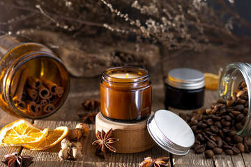 A set of different aroma candles in brown glass jars. Scented handmade candle. Soy candles are burning in a jar. Aromatherapy and relax in spa and home.