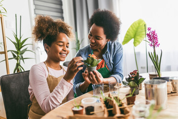 Mother and daughter planting at home.