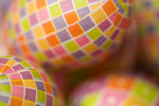 Easter egg decorations--close-up, full frame, abstract, image focus technique background texture of colorful, check pattern, paper covered Easter eggs