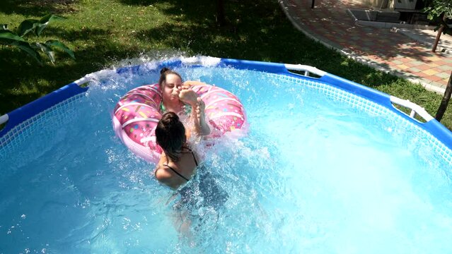 Children play fun swimming pool games on sunny summer day, vacation
