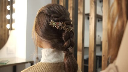 Hairdresser finishing hairstyle for her client at the hair salon.