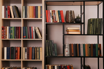 Collection of different books on shelves in home library - obrazy, fototapety, plakaty
