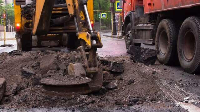 Excavator Conducts Earthwork. Repair work on the motorway. Excavator digs communications unit water supply on which the accident occurred