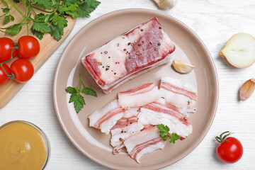 Tasty salt pork with parsley served on white wooden table, flat lay