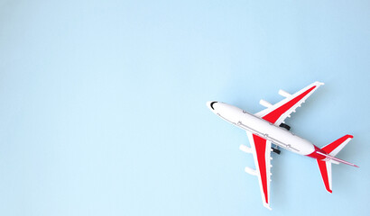 Flat lay, airplane model on blue background.  The concept of minimalism travel, vacation, vacation.  Booking tickets online on the site.  Space for copy text.  Banner.  Background picture.