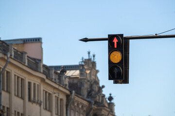 Traffic light with a burning red arrow straight ahead and a yellow signal