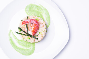 risotto with shrimp and zucchini cooked by chef on white background with very bright light and  horizontal shot