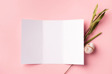 Happy Easter greeting card mock up. Empty brochure with Easter egg and eucalyptus branch on pink background.