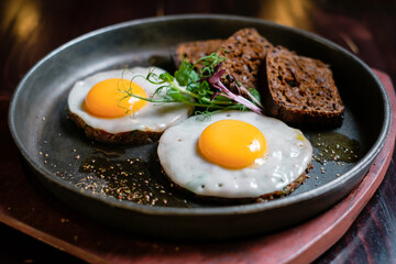 Tasting fried eggs. Eating eggs and tartare with a fork.