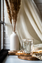 a glass of clean water on a table by the window, the right habits