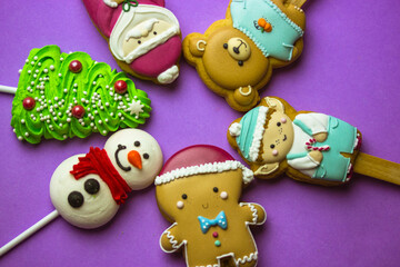 Cookies on sticks in a shape of Santa Claus, elf character, Gingerbread man, snowman, bear, New...