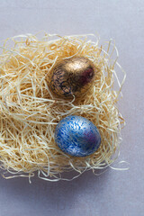 Decorated and painted easter eggs in straw nest