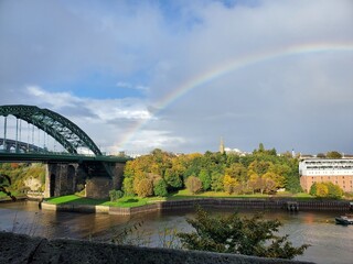 Fototapeta na wymiar rainbow bridge over the river