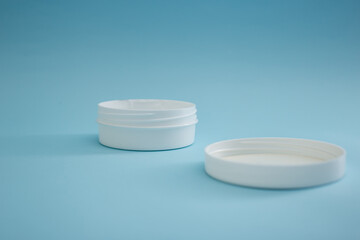 Jar of cream on a blue background, beauty and body care industry