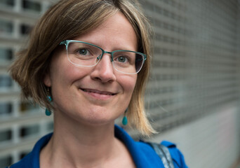 Brussels Old Town, Belgium - Portrait of a thirty year old young white woman with glasses with a...