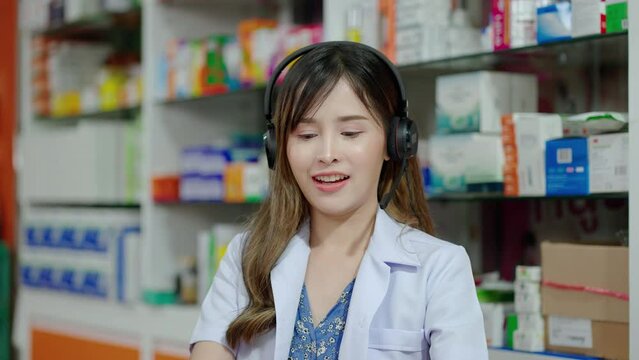 Asian female pharmacist is meeting online with patients to educate patients on how to use the right medicine for symptoms, social media, social distancing.
