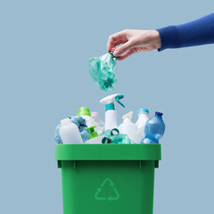 Woman putting plastic in the recycling bin