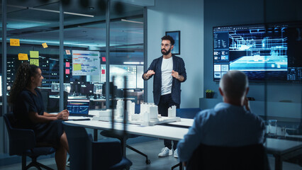 Creative Architect Holds Meeting Presentation of a New Housing Project for a Team of Real Estate Investors. Adult Male Uses TV Screen with Technical Drawings, 3D Renders and Engineering Plans