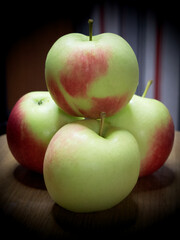 A bunch of juicy red-sided apples, a close-up shot. Ripe fruit.