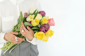 Beautiful bouquet of tulips in female hands