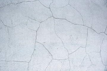 White black grey concrete wall, floor with cracks, texture background. The cracked white plaster wall. White wall with cracks. Crack white wall texture.
