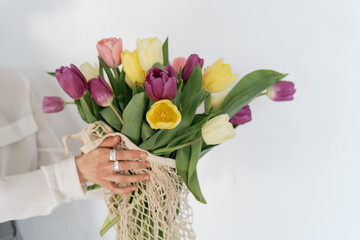 Fresh bouquet of tulips in a hand