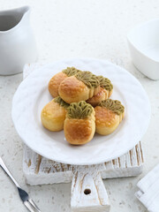 Nastar Cookies, Taiwanese Pineapple Cookies with pineapple-shaped filled with jam. Served on plate.