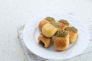 Nastar Cookies, Taiwanese Pineapple Cookies with pineapple-shaped filled with jam. Served on plate.