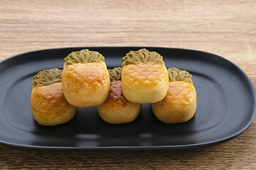 Fototapeta na wymiar Nastar Cookies, Taiwanese Pineapple Cookies with pineapple-shaped filled with jam. Served on plate.