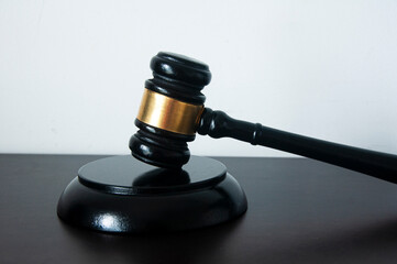 Lawyer gavel on wooden table with white background.