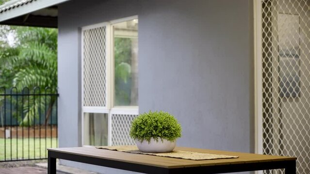 Outside patio verandah with table chairs and plant