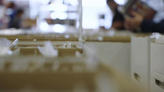 Rack focus people reading comic books store boxes slow motion 4K