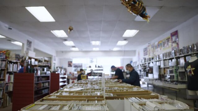 Tilt Down comic book boxes store slow motion 4K