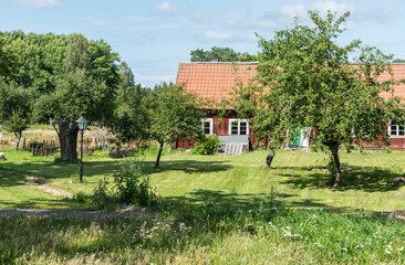 Ulva, Uppland - Sweden - Typical red wooden Swedish summer countryhouse and garden