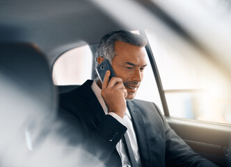 Im headed in to the office as we speak. Cropped shot of a handsome mature businessman making a call...