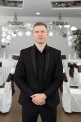 Handsome young man in a suit in a restaurant.