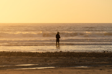Fototapeta na wymiar A man fishing at sunset.