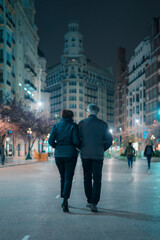 A couple walks through the city