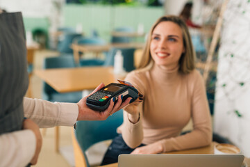 close up of woman paying with credit card in cafeteria